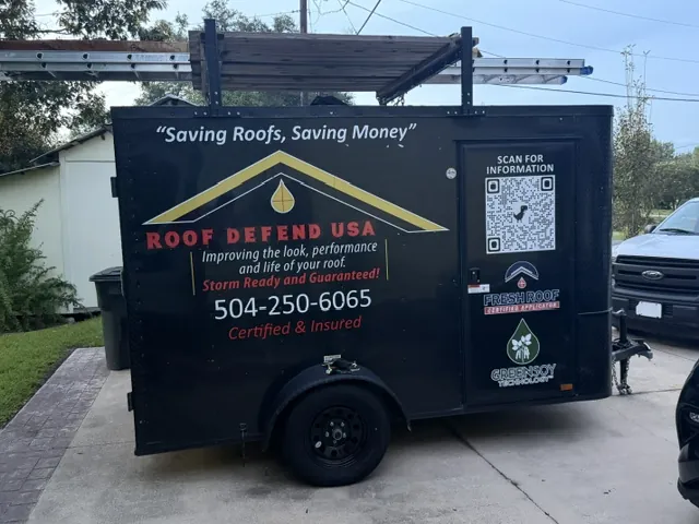 The black Roof Defend USA trailer with the logo, a QR code and the phone number (504) 250-6065