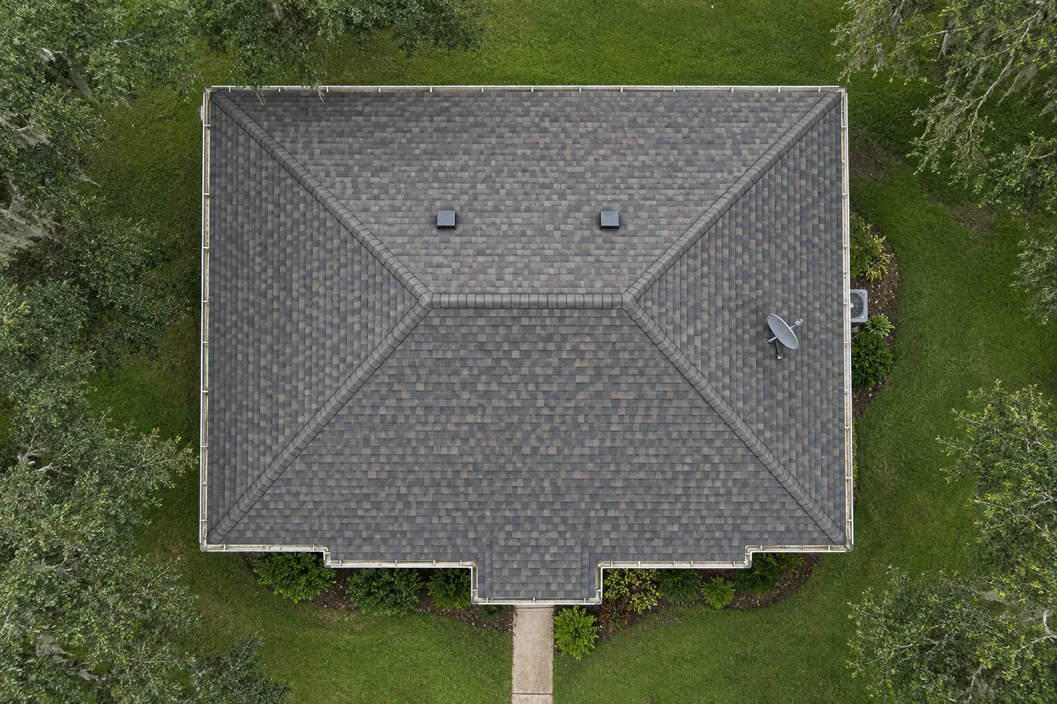 Top-down drone view of a hip roof with the ridge, vents, hip lines and a dish mount marked